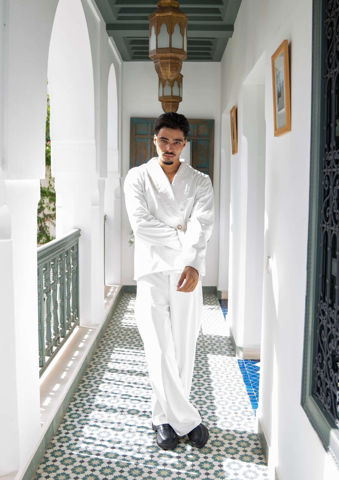Simo Toutaj in a white suit in a riad